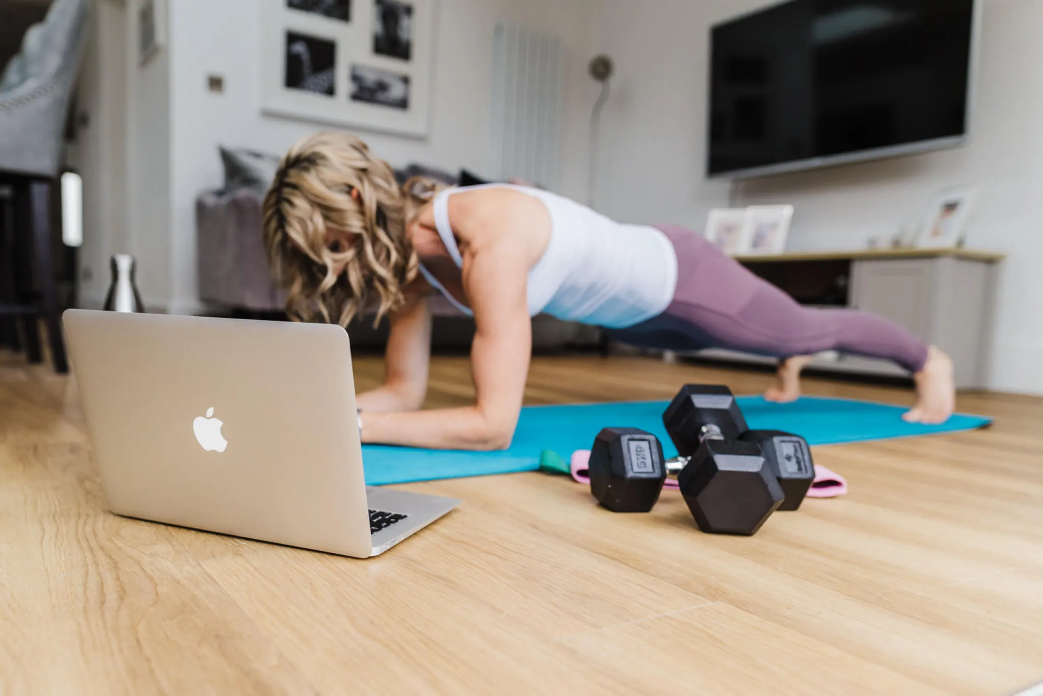 Athlete performing a bodyweight squat in a minimal indoor space